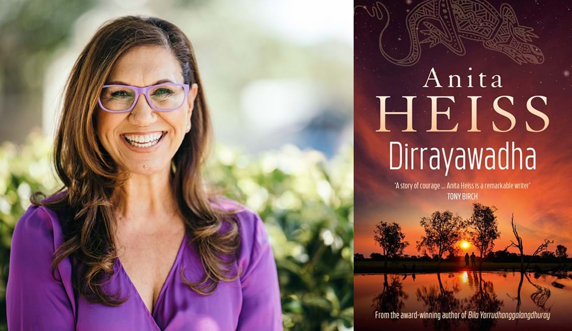 Anita Heiss Wears a purple top and glasses with purple frames. She has long wavy brown hair and is smiling. The book jacket has an image of a sunset reflected over a body of water.